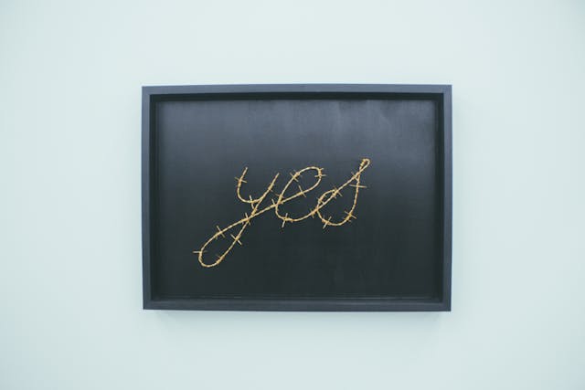 A vibrant and repetitive image showcasing a text that says 'yes' multiple times, against a dining room wall decor.