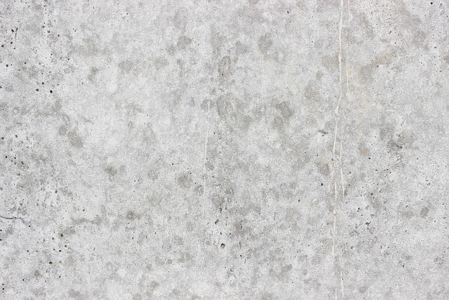 Close-up of concrete wall painted white, showing texture. Contact paper vs wallpaper comparison.